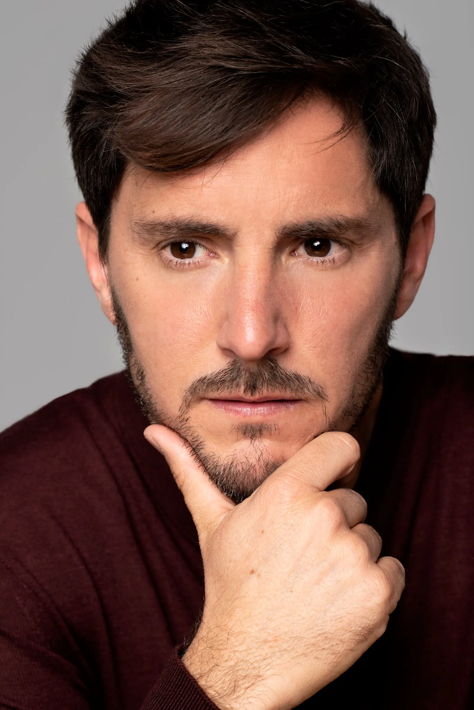 Bernardo Rivera, actor, con jersey granate y mano en la barbilla